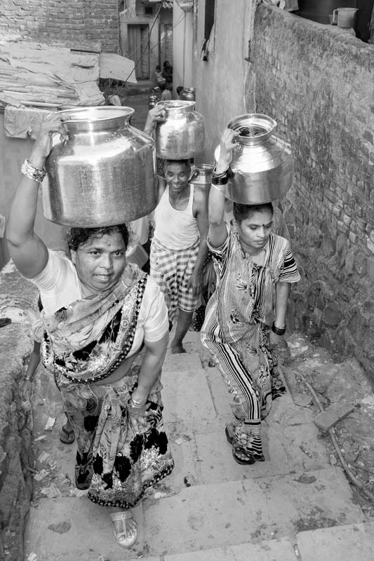 Human Right to Water in Mumbai - Making multiple trips over stairs with headloads of water